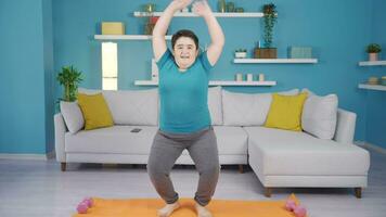 Obesity boy doing exercises at home. video