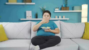 Obesity boy eat chips, enjoy and be happy. video