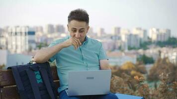 Businessman chatting online face to face with his girlfriend in the park. video