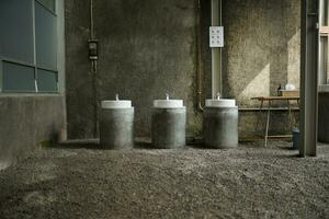 Solo, Indonesia - June 10, 2022 an industrial style porcelain and concrete handwashing station photo