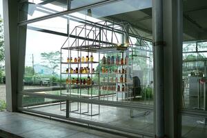 herbal medicine production, medicine bottles on the shelves are neatly arranged with buildings made of glass. photo