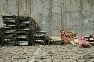 iron rafters of various types in front of a concrete wall in a collector's place photo