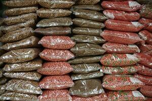 animal market, red colorful farm animal feed pellets. bird and fish feed in packaged form photo