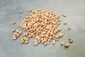 fresh peanuts on concrete background photo