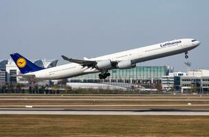 Lufthansa passenger plane at airport. Schedule flight travel. Aviation and aircraft. Air transport. Global international transportation. Fly and flying. photo