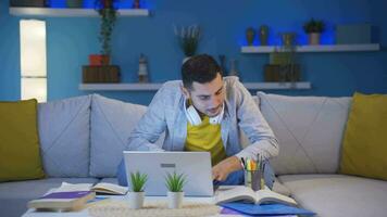 Stressed and depressed male student at home at night. video