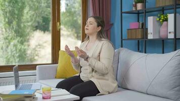 Muslim woman praying in front of the window. video