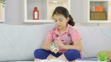 Girl child playing with a intelligence cube. video