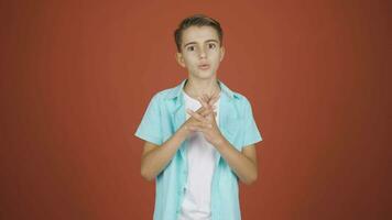 Boy looking at camera making confidence sign. video