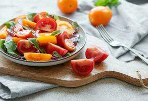 Green salad from leaves and tomatoes photo