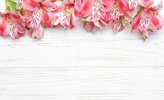 Beautiful Alstroemeria flowers on wooden background photo