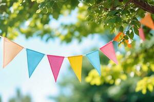 Colorful pennant  decoration in green  foliage on blue sky photo