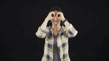 Woman with binoculars looking away. video