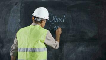 Engineer man writes Direct Current on the board. video