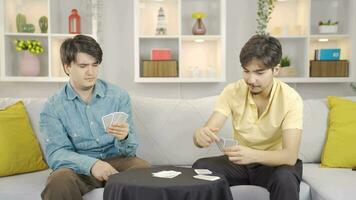 Friends are playing poker together at home, they are cheerful and peaceful. video