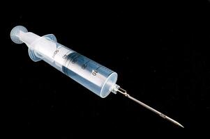 a syringe with a needle on top of it photo