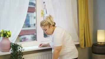 Obesity woman is depressed in front of the glass and does not feel psychologically well. video