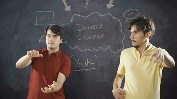 Young man writing Driver's License on blackboard. video