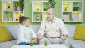 Grandfather and grandson holding hands. video