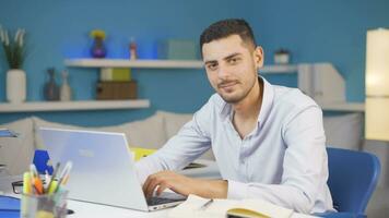 Home office worker man waving at camera. video