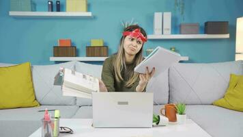 Stressed schoolgirl bored of looking at books. video