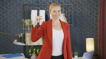 The woman making the small sign with her hand. video