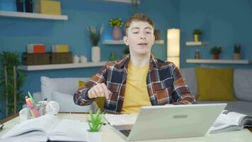 Student relaxes after completing homework on laptop. video