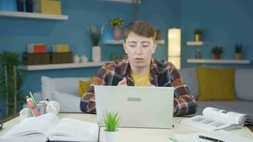 Frustrated student turns off his laptop and stops doing homework. video