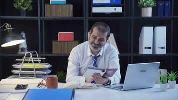 Depressed businessman looking at family photo album. video