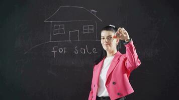 Woman writing for sale on blackboard hands key to camera. video