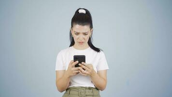 Woman looking sad at phone with Green Screen. video