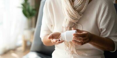 Close up mature woman taking out pills from bottle, supplements or antibiotic, older female preparing to take emergency medicine, chronic disease, healthcare and treatment concept photo