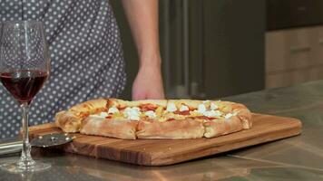 Man grabbing piece of delicious pizza from the table video