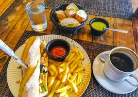 Baguette sandwich toast bread with chicken tomato salad potatoes fries. photo