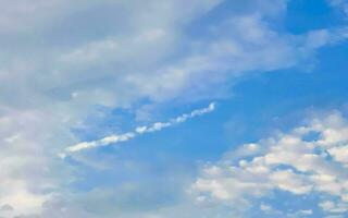 Blue sky with chemical chemtrails cumulus clouds scalar waves sky. photo