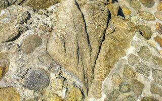 Texture detail of wall with rocks stones brick bricks Mexico. photo