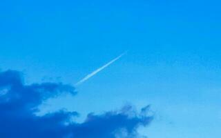 Blue sky with chemical chemtrails cumulus clouds scalar waves sky. photo