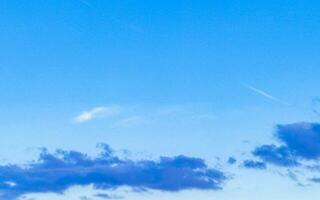 Blue sky with chemical chemtrails cumulus clouds scalar waves sky. photo