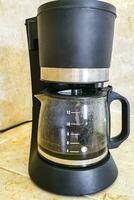 Black coffee maker from Mexico on cream background in kitchen. photo