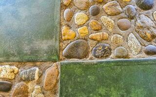 Texture detail of wall with green rocks stones in Mexico. photo