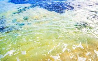 Stones rocks corals turquoise green blue water on beach Mexico. photo