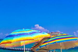 Colorful parasol with many colors on the Caribbean beach in Mexico. photo