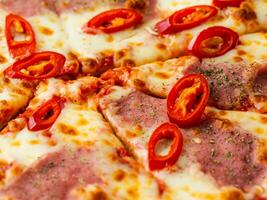 pizza with meat, mushrooms, tomatoes, cheese and peppers on white plate photo