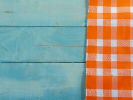 top view of orange striped towel on wooden table photo