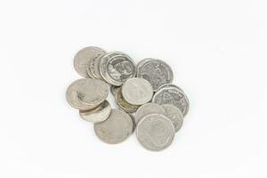 Pile of old coins isolated on white background with clipping path. photo