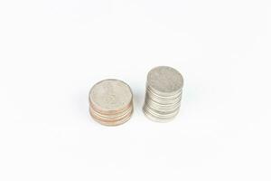 Coins stacked on each other in different positions on a white background photo