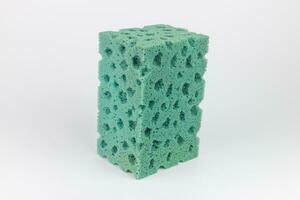 Green sponges for washing dishes on a white background closeup photo