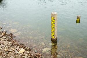 concrete poles used to measure the level of water and river in the dam of Thailand. photo