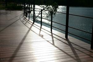puente y de madera pasarela junto a el lago con natural luz de sol foto