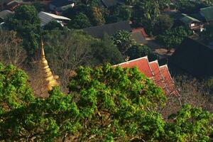 Heritage Golden Buddha statue and pagoda located in the forest and on the mountain in northern of Thailand Bird eye view photo